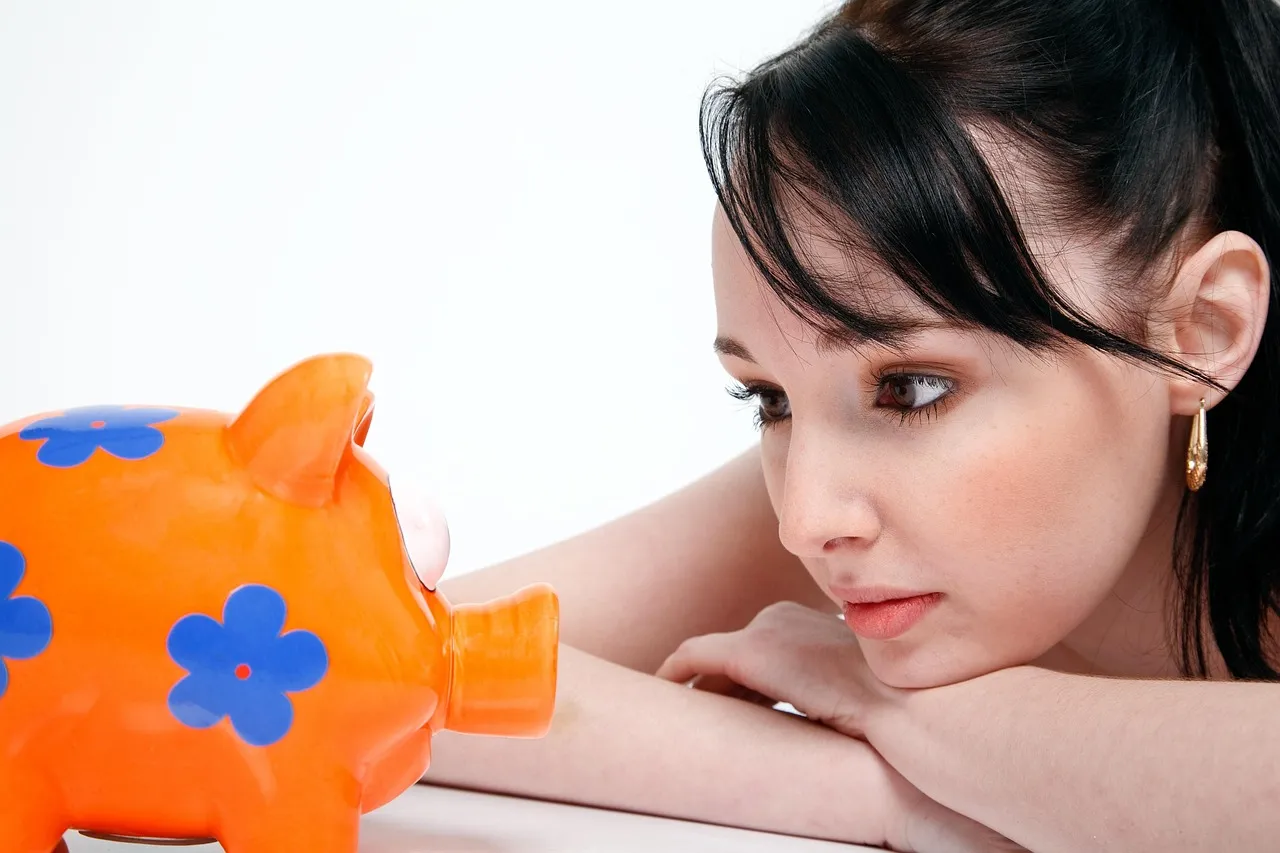 Photo showing piggy bank, saving, money and young woman.