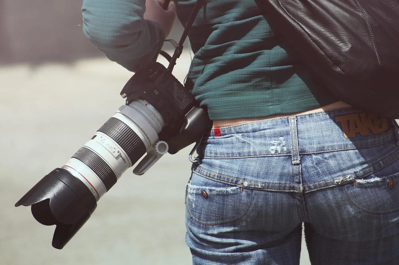 Photo showing woman, photographer and camera.