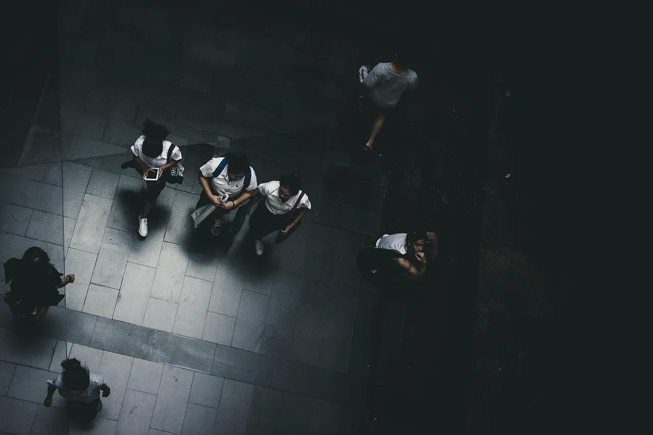 Photo showing street, people, students and uniform.