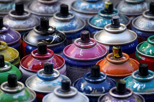 Photo showing spray, cans and colour.