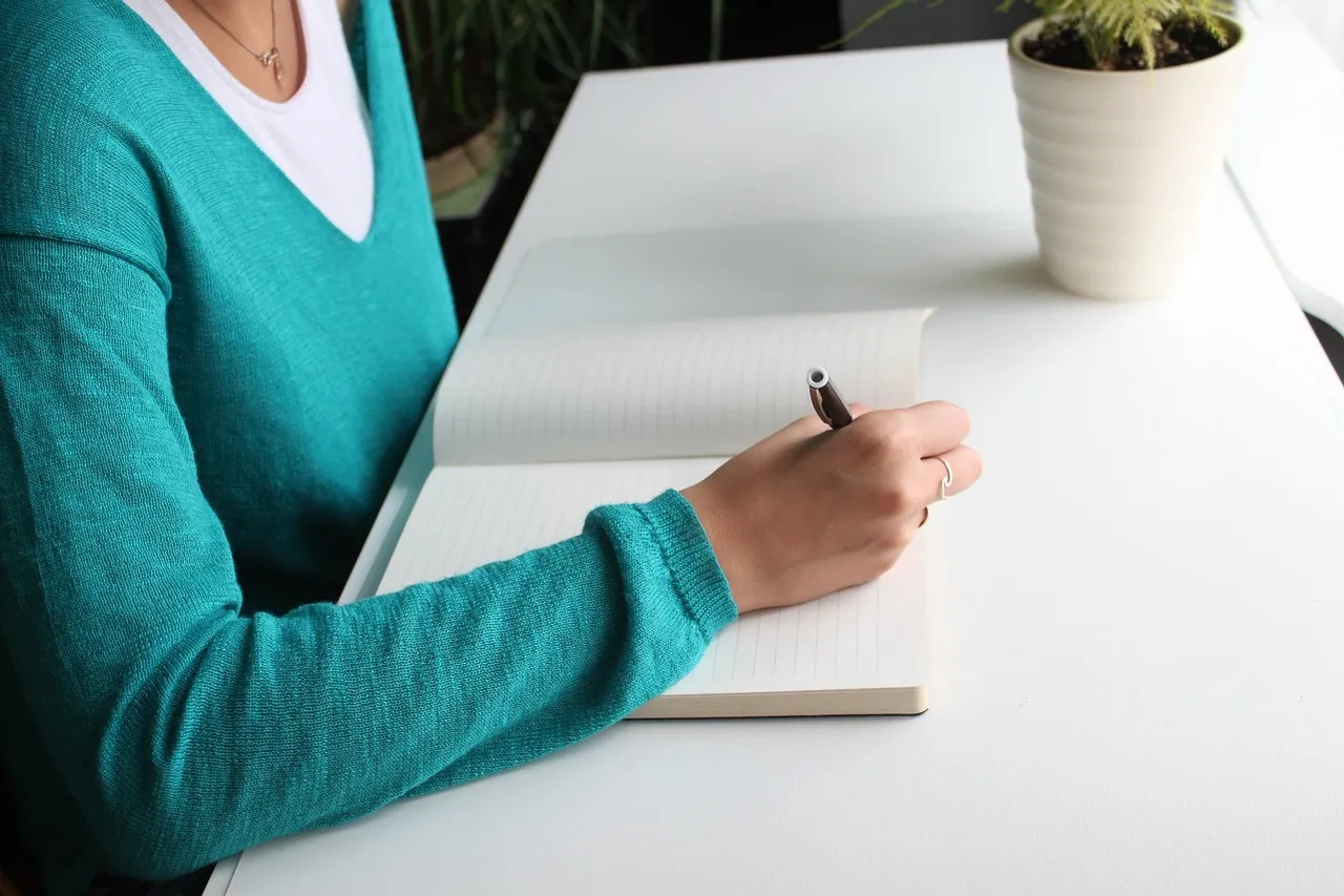 Photo showing writing, blue, desk and write.
