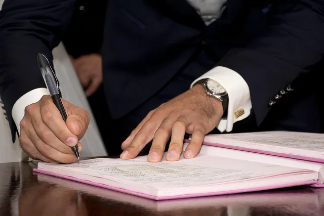 Photo showing mayor, signature and sign.