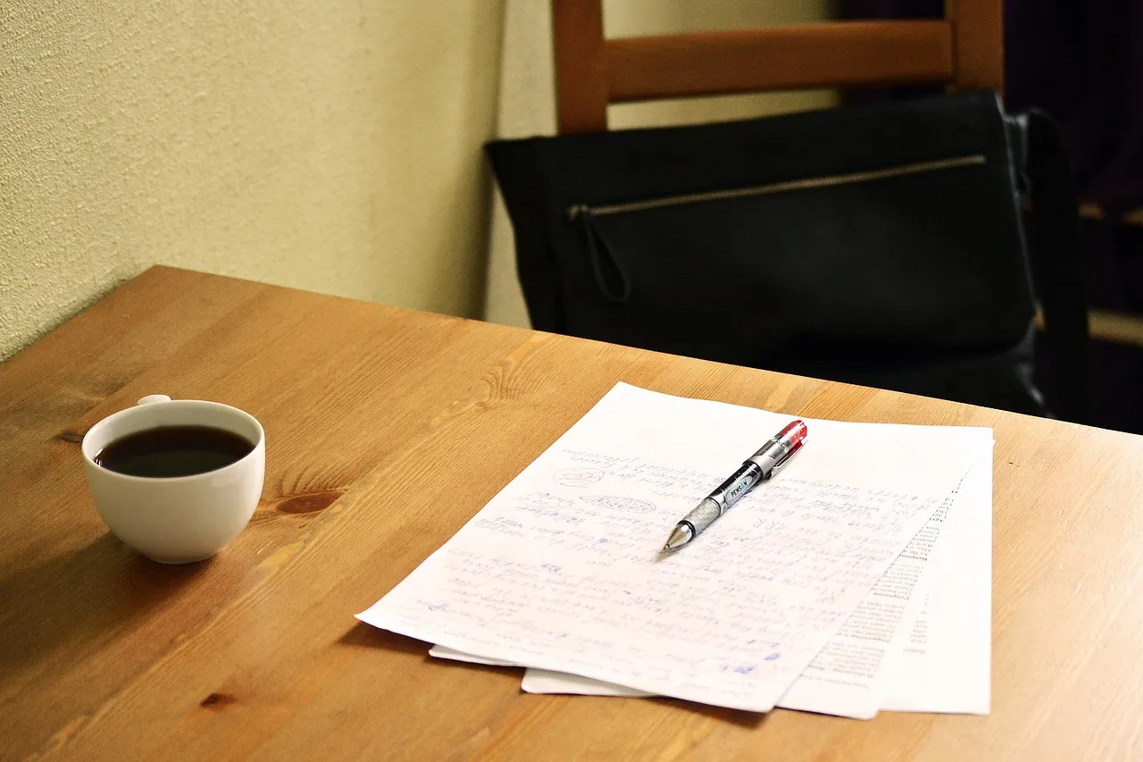 Photo showing correcting, papers and english teacher.